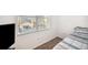 Sunlit bedroom with a pool view from the window, carpet flooring, and a television at 1200 Country Club Dr # 2206, Largo, FL 33771