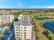 Elevated view of a condo building situated near a golf course and a picturesque pond, offering scenic surroundings at 1200 Country Club Dr # 2206, Largo, FL 33771
