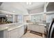 Modern kitchen featuring white cabinetry, stainless steel appliances, and an open layout to the dining area at 1200 Country Club Dr # 2206, Largo, FL 33771