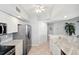 Bright kitchen with marble countertops, stainless steel appliances, tile floors, and white cabinets at 1200 Country Club Dr # 2206, Largo, FL 33771