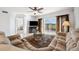 Bright living room featuring comfortable seating, entertainment center, and access to the outdoor balcony with scenic golf views at 1200 Country Club Dr # 2206, Largo, FL 33771