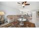 Spacious living room features a plush sofa, ceiling fan, and access to the kitchen at 1200 Country Club Dr # 2206, Largo, FL 33771