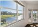 Bright room with large windows showing golf course and water views with a sunroom/balcony on the right at 1200 Country Club Dr # 2206, Largo, FL 33771