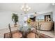 A decorative chandelier accentuates the dining area, with a glimpse into the living room at 1200 Country Club Dr # 2206, Largo, FL 33771