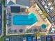 Overhead shot of community pool with lounge chairs and umbrella tables at 1200 Country Club Dr # 2206, Largo, FL 33771