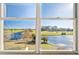 Window view showcasing a golf course, pond, trees, and clear blue skies at 1200 Country Club Dr # 2206, Largo, FL 33771