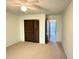 Bedroom featuring carpeted floors, closet with paneled doors, and an open doorway at 12155 Environmental Dr # 6, New Port Richey, FL 34654