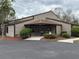 Exterior view of the community clubhouse showcasing a welcoming entrance and well-maintained landscaping and convenient parking at 12155 Environmental Dr # 6, New Port Richey, FL 34654