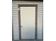 Exterior shot of the door on a building featuring light siding and a darker trim, with unit number six located nearby at 12155 Environmental Dr # 6, New Port Richey, FL 34654