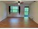 Living room with ceiling fan, windows, and door to balcony at 12155 Environmental Dr # 6, New Port Richey, FL 34654
