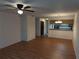 Spacious living area with a ceiling fan, wood-look flooring, and an open layout at 12155 Environmental Dr # 6, New Port Richey, FL 34654
