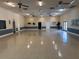 Spacious meeting room boasts neutral paint and ceiling fans with a smooth floor, ideal for gatherings at 12155 Environmental Dr # 6, New Port Richey, FL 34654