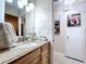 Bathroom featuring granite countertops, wood cabinets, and decorative accents at 1216 Lotus Path, Clearwater, FL 33756