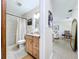 Bathroom with walk-in shower, wood vanity, and access to hallway and living room at 1216 Lotus Path, Clearwater, FL 33756