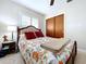 Bedroom features a comfortable bed with shutters on windows and a closet at 1216 Lotus Path, Clearwater, FL 33756