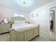 Light pink bedroom features a chandelier, floral decor, and neutral furniture at 1216 Lotus Path, Clearwater, FL 33756