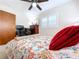 Bright bedroom with a floral bed, desk, dresser, and shuttered window at 1216 Lotus Path, Clearwater, FL 33756