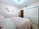 Light pink bedroom includes a large bed, closet, and floral wall art at 1216 Lotus Path, Clearwater, FL 33756