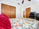Bedroom featuring a bed with floral pattern with a view of closet at 1216 Lotus Path, Clearwater, FL 33756