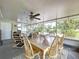 Enclosed porch with dining table and chairs, providing a versatile living space at 1216 Lotus Path, Clearwater, FL 33756