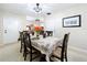 Well-lit dining room showcasing a stylish table setting, decorative lighting, and access to other living spaces at 1216 Lotus Path, Clearwater, FL 33756