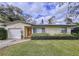 Charming single-story home with a well-maintained lawn and a cozy, inviting entrance at 1216 Lotus Path, Clearwater, FL 33756