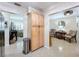 Hallway has a storage closet and leads into seating areas with beautiful decor at 1216 Lotus Path, Clearwater, FL 33756