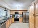 Modern kitchen featuring stainless steel appliances, ample counter space, and stylish cabinetry at 1216 Lotus Path, Clearwater, FL 33756