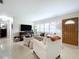 Cozy living room featuring neutral tones, plantation shutters, and stylish decor accents at 1216 Lotus Path, Clearwater, FL 33756