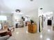 Open living room with terrazzo floors, neutral walls, and ample natural light at 1216 Lotus Path, Clearwater, FL 33756