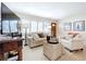 Comfortable living room featuring neutral-toned furniture, plantation shutters, and ample natural light at 1216 Lotus Path, Clearwater, FL 33756
