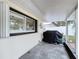 Covered patio with stained concrete, BBQ grill, and pass through window to an interior space at 1216 Lotus Path, Clearwater, FL 33756