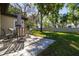 Enjoy outdoor dining on the paved patio with a table, chairs and lush lawn at 12200 Vonn Rd # 6D, Largo, FL 33774