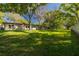 Sprawling green lawn and mature trees create a peaceful backyard oasis at 12200 Vonn Rd # 6D, Largo, FL 33774