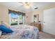 Bedroom boasts a window with street view, and a vanity with mirror at 12200 Vonn Rd # 6D, Largo, FL 33774