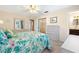 Light and bright bedroom featuring a sliding closet, a window, and a dresser at 12200 Vonn Rd # 6D, Largo, FL 33774