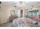 Light bedroom with a ceiling fan, closet, and a vanity with mirror at 12200 Vonn Rd # 6D, Largo, FL 33774