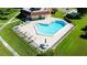 A gorgeous aerial view of a community pool with plenty of lounge chairs and shaded tables for residents at 12200 Vonn Rd # 6D, Largo, FL 33774