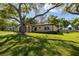 Charming single-story home with a lush green lawn and mature shade trees at 12200 Vonn Rd # 6D, Largo, FL 33774