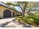 Well-maintained single-story home with an attached garage and mature trees in a residential neighborhood at 12200 Vonn Rd # 6D, Largo, FL 33774