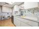 Functional kitchen with stainless steel sink, appliances, and a built in desk at 12200 Vonn Rd # 6D, Largo, FL 33774
