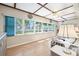 Bright living room with large windows, hardwood floors, and comfortable seating area at 12200 Vonn Rd # 6D, Largo, FL 33774