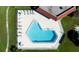 Aerial view of a unique heart-shaped pool surrounded by lounge chairs and well-maintained landscaping at 12200 Vonn Rd # 6D, Largo, FL 33774