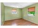 Neutral bedroom with hardwood floors and two windows providing natural light at 12704 128Th Ln, Largo, FL 33774