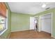 Green painted bedroom featuring a closet, window and hardwood floors at 12704 128Th Ln, Largo, FL 33774