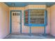 Inviting front porch with a bay window and a door, creating curb appeal at 12704 128Th Ln, Largo, FL 33774