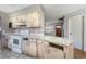 Rustic kitchen featuring vintage white appliances and cabinetry against gray walls at 12704 128Th Ln, Largo, FL 33774