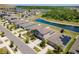 Stunning aerial shot of modern homes and a serene pond, showcasing community charm and appeal at 14618 Scottburgh Glen Dr, Wimauma, FL 33598