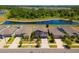 Aerial view of residential neighborhood featuring several well-maintained homes next to a scenic pond at 14618 Scottburgh Glen Dr, Wimauma, FL 33598
