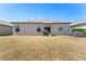 A spacious backyard features a grill, a lawn, and AC units at 14618 Scottburgh Glen Dr, Wimauma, FL 33598